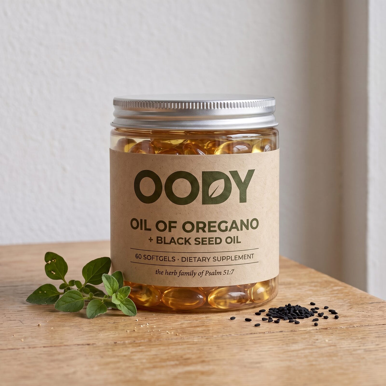 OODY Oil of Oregano + Black Seed Oil jar on an oak table