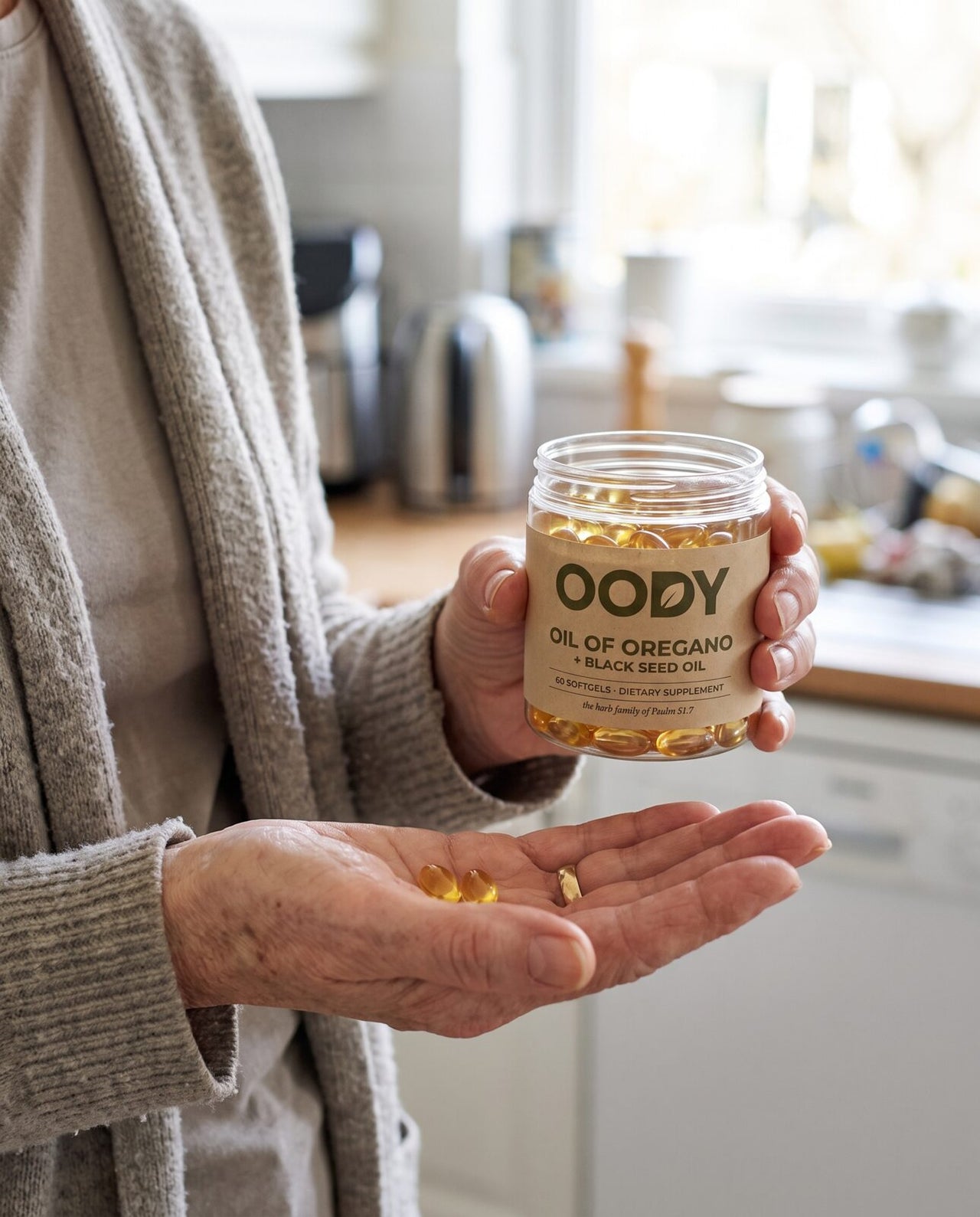 Golden softgels tipped from the OODY jar into a hand