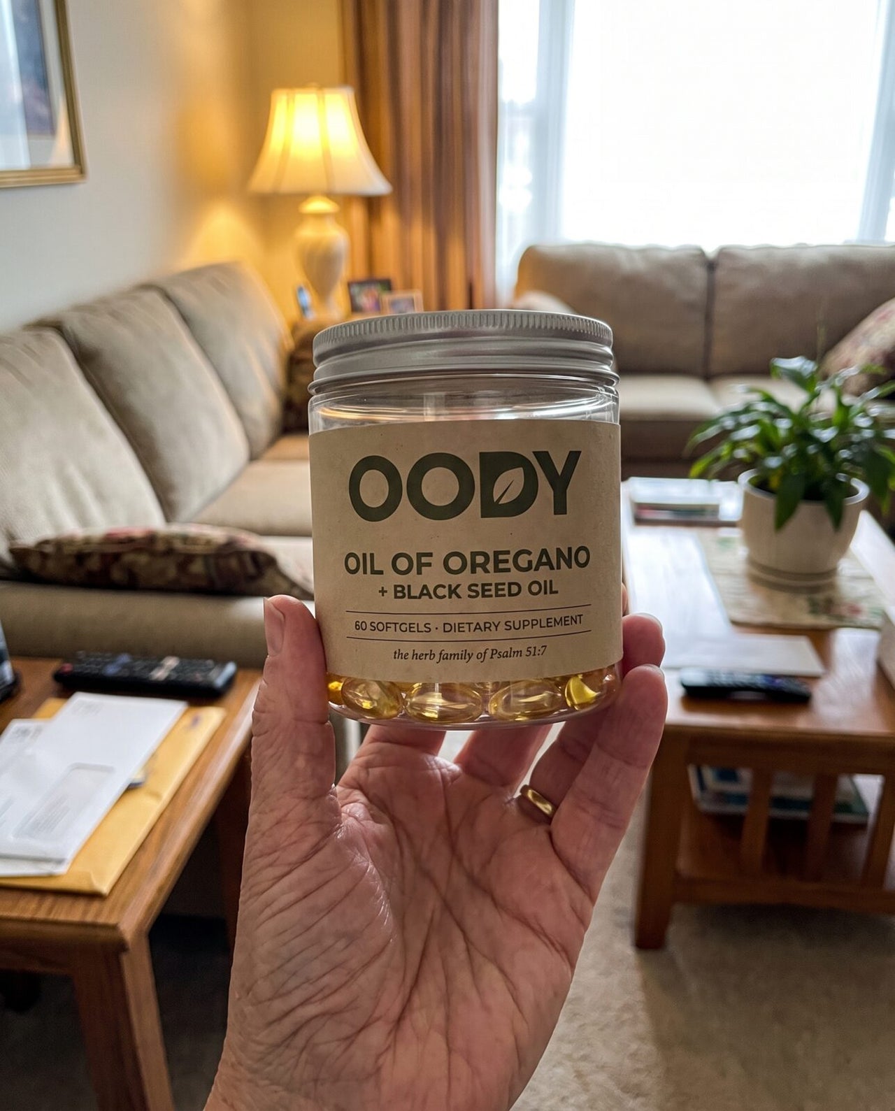 OODY jar held in a hand to show its size